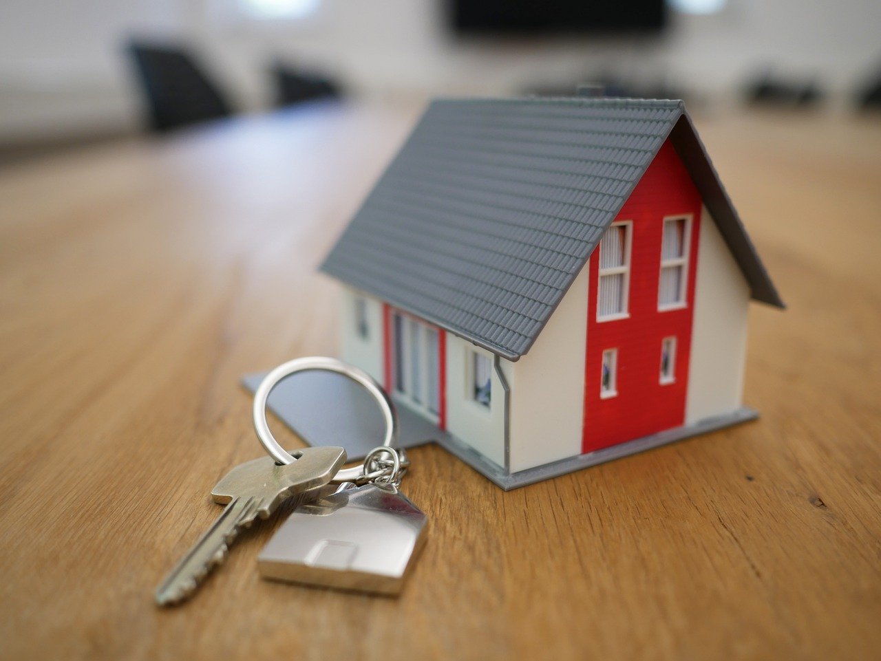 a small house with key on top of a table